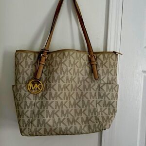 Michael Kors lovingly used, but has much more life to this signature bag.